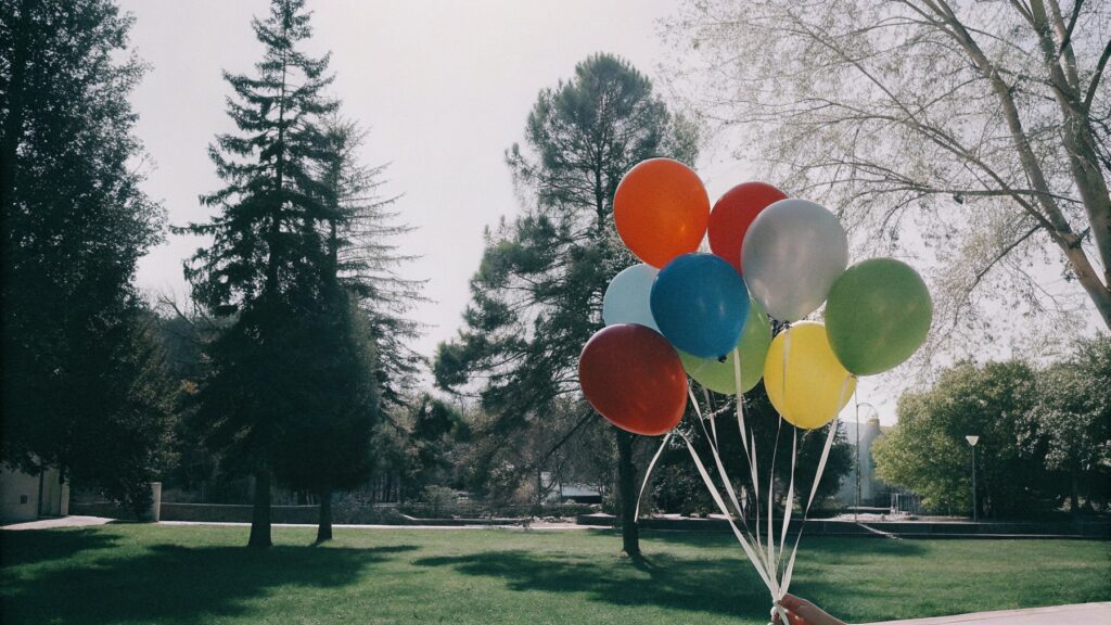 A colorful display of latex balloons in a park
