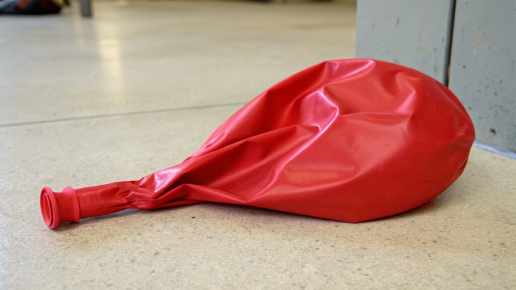A deflated red balloon