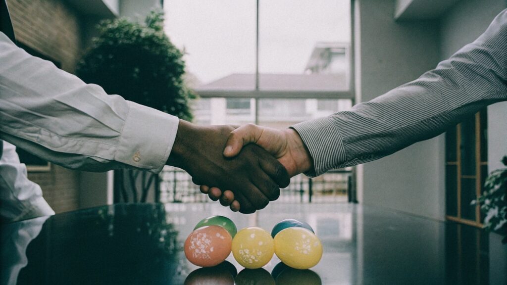 A handshake over a table with FSC-certified balloon samples