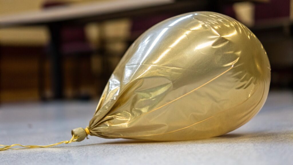 Deflated latex balloon showing wrinkles