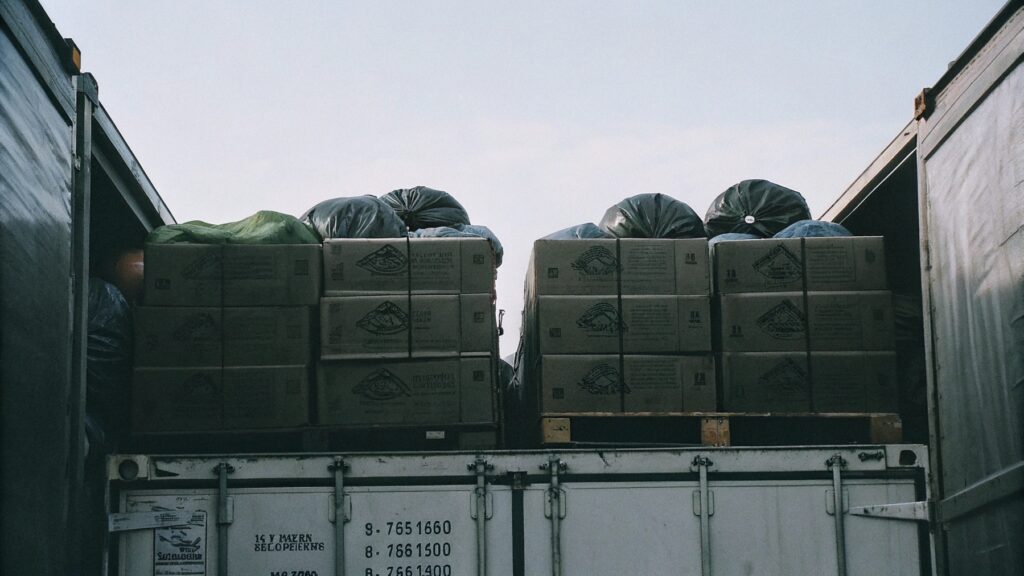 Boxes of deflated balloons being loaded onto a shipping container
