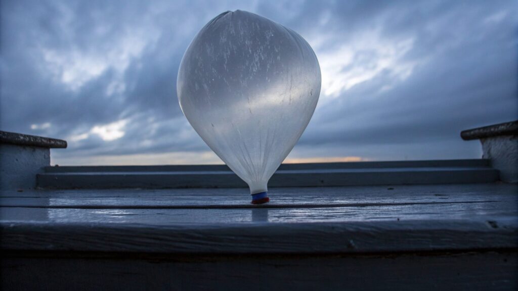 An overinflated balloon, noticeably stretched, about to burst
