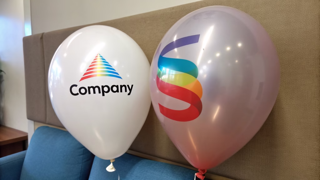 A foil balloon with a perfectly printed company logo next to a latex balloon with a simpler logo