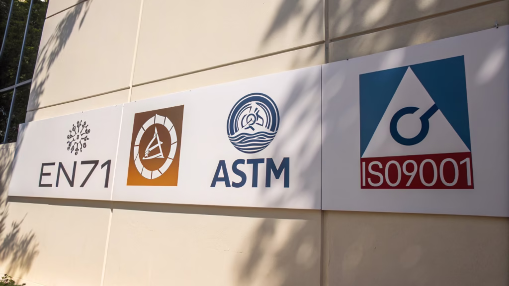 A collage of safety standard logos like EN71, ASTM, and ISO9001