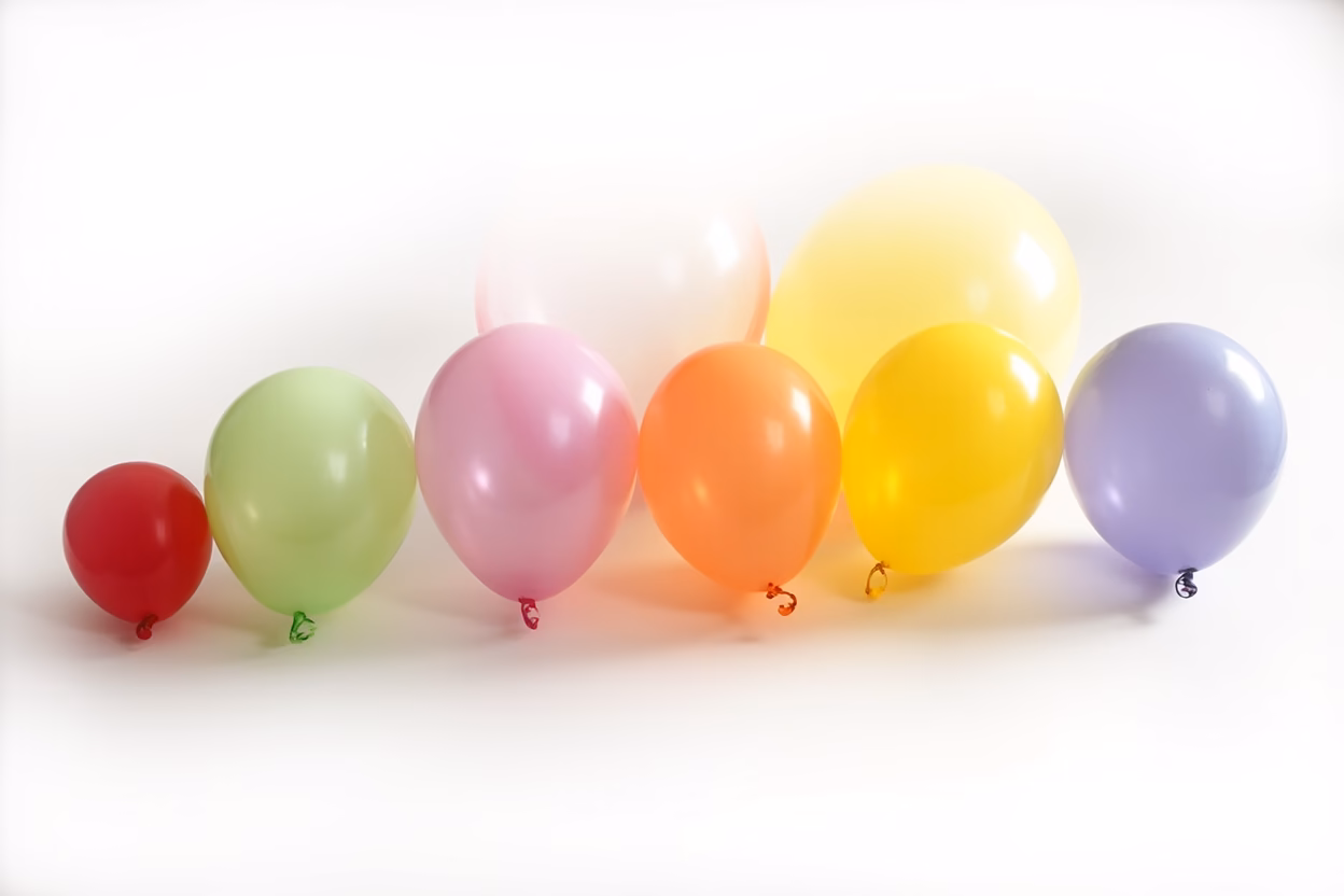 Balloon Size in Professional Decorating Professional decorator arranging large balloons for a corporate event backdrop