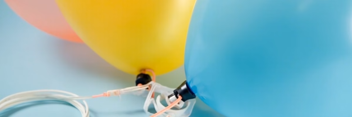 Balloon neck stretching over sizer ring as it reaches the correct diameter