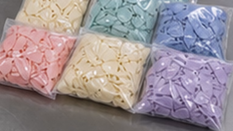 Custom balloons wholesale sample bags on a QC table